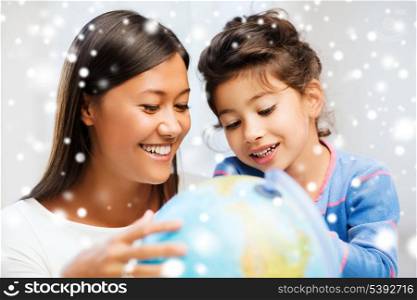 family, children, education, school and happy people concept - mother and daughter with globe