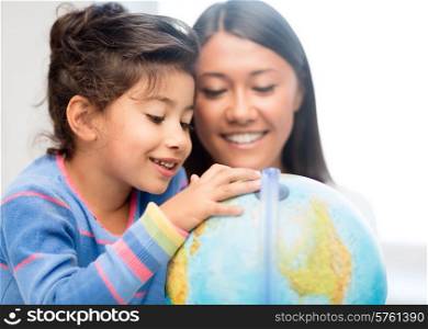 family, children, education, school and happy people concept - mother and daughter with globe
