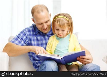 family, children, education, school and happy people concept - smiling father and daughter with book at home