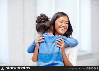 family, children, love and happy people concept - happy mother and daughter hugging at home