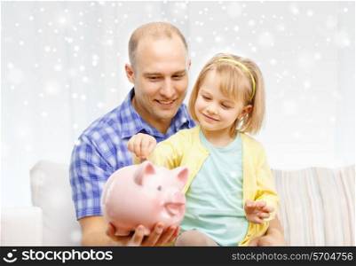 family, children, money, investments and happy people concept - happy father and daughter with big pink piggy bank