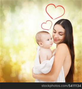 family, children, parenthood and happiness concept - happy mother feeding her adorable baby
