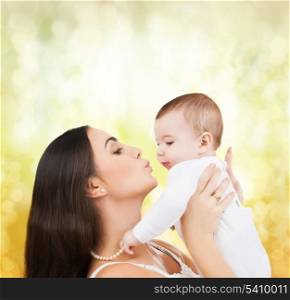 family, children, parenthood and happiness concept - happy mother kissing her child