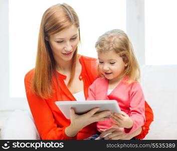 family, children, parenthood, technology and internet concept - happy mother and daughter with tablet pc computer at home