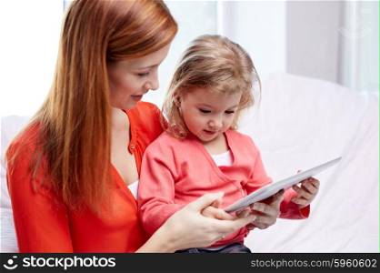 family, children, parenthood, technology and internet concept - happy mother and daughter with tablet pc computer at home
