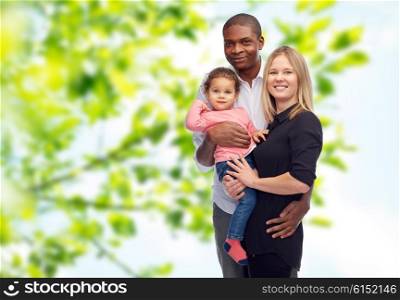 family, children, race and nationality concept - happy multiracial mother, father and little child over green natural background