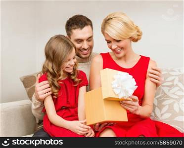 family, christmas, happiness and people concept - happy family opening gift box