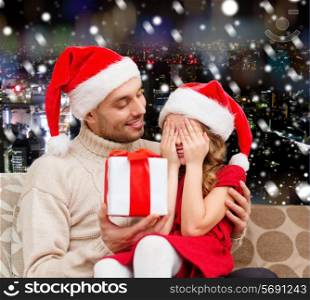 family, christmas, winter holidays and people concept - smiling daughter with closed eyes waiting for present from father over snowy night city background