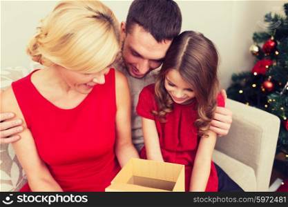 family, christmas, winter holidays, happiness and people concept - happy family opening gift box