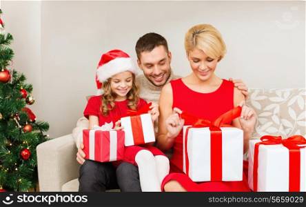 family, christmas, x-mas, happiness and people concept - happy family opening gift boxes