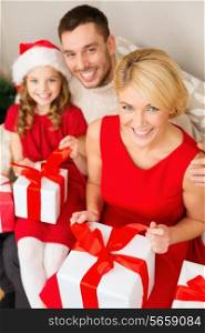 family, christmas, x-mas, happiness and people concept - happy family opening gift boxes