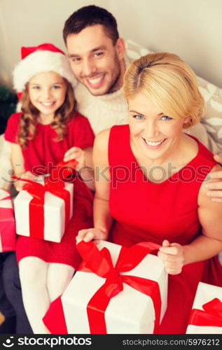 family, christmas, x-mas, happiness and people concept - happy family opening gift boxes