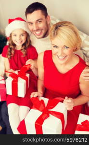 family, christmas, x-mas, happiness and people concept - happy family opening gift boxes