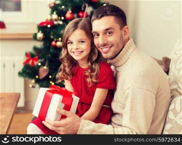 family, christmas, x-mas , happiness and people concept - smiling father and daughter holding gift box