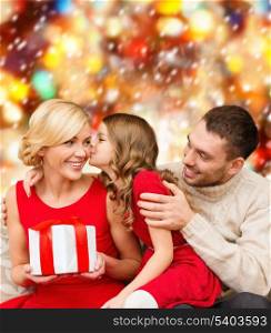 family, christmas, x-mas, winter, happiness and people concept - adorable child kisses her mother and gives present