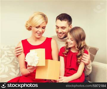 family, christmas, x-mas, winter, happiness and people concept - happy family opening gift box