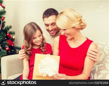 family, christmas, x-mas, winter, happiness and people concept - happy family opening gift box