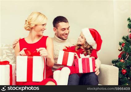 family, christmas, x-mas, winter, happiness and people concept - happy family opening gift boxes