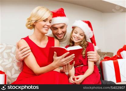 family, christmas, x-mas, winter, happiness and people concept - smiling family in santa helper hats with many gift boxes reading book