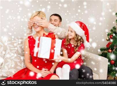 family, christmas, x-mas, winter, happiness and people concept - smiling father and daughter surprise mother with big gift box