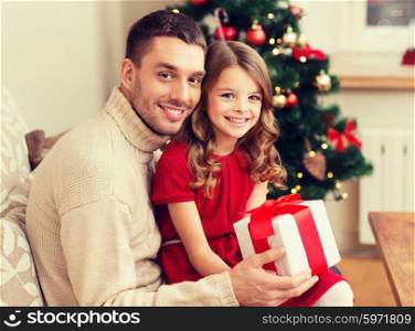 family, christmas, x-mas, winter, happiness and people concept - smiling father and daughter holding gift box