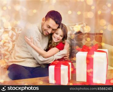 family, christmas, x-mas, winter, happiness and people concept - smiling father and daughter hugging