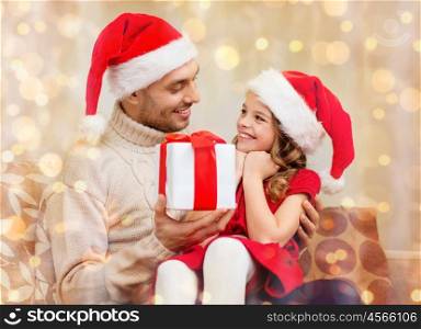 family, christmas, x-mas, winter, happiness and people concept - smiling father giving daughter gift box