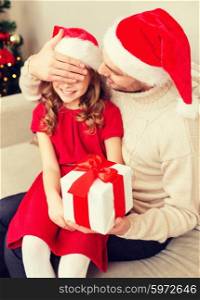 family, christmas, xmas, happiness and people concept - smiling father surprise daughter with gift box covering eyes with hand