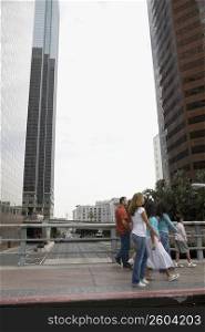 Family crossing bridge in downtown Los Angeles