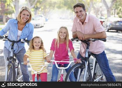 Family Cycling On Suburban Street