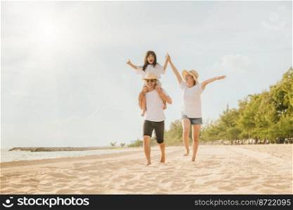 Family day. Happy family people having fun in summer vacation run on beach, daughter riding on father back and mother running at sand beach, family trip playing together outdoor, traveling in holiday