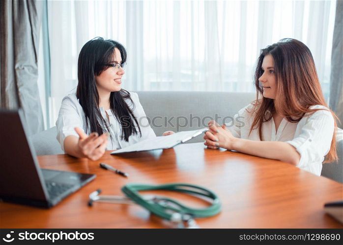 Family doctor examination, young wife talks with specialist. Female patient on cosultation, professional health care. Family doctor, young wife talks with specialist