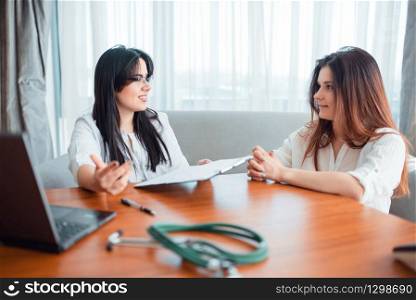 Family doctor examination, young wife talks with specialist. Female patient on cosultation, professional health care. Family doctor, young wife talks with specialist