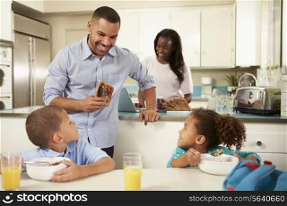 Family Eating Breakfast At Home Together