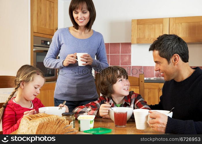 Family Eating Breakfast Together In Kitchen