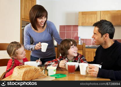 Family Eating Breakfast Together In Kitchen