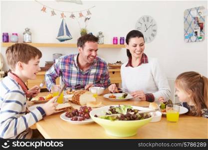 Family Eating Lunch At Kitchen Table