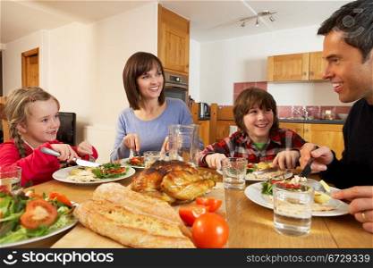 Family Eating Lunch Together In Kitchen