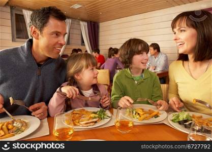 Family Eating Lunch Together In Restaurant