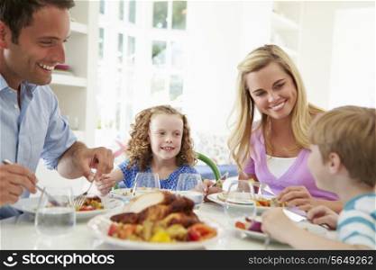 Family Eating Meal At Home Together