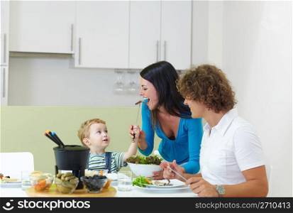 family eating meat fondue