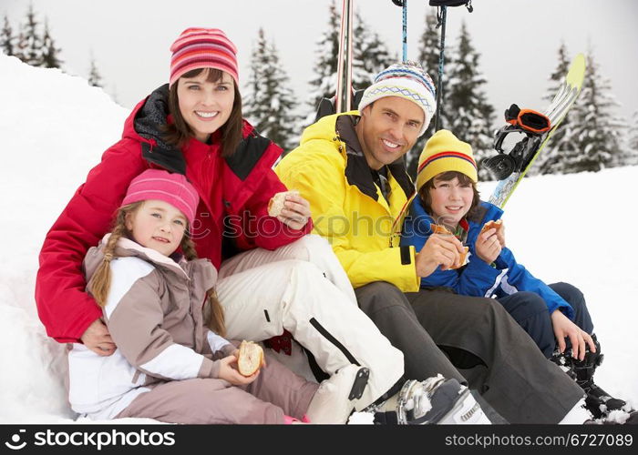 Family Eating Sandwich On Ski Holiday In Mountains