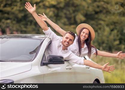 Family enjoy summer vacation. by the car Happy couple tourists look from car. Young couple tourist enjoying on summer vacation