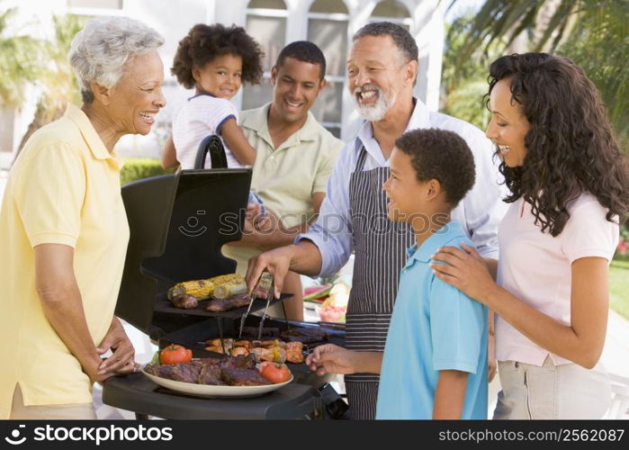 Family Enjoying A Barbeque