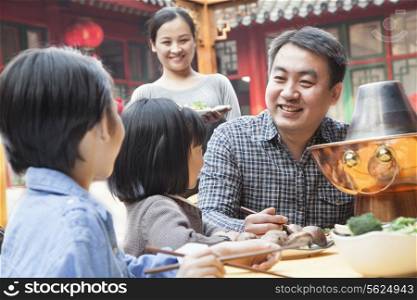 Family enjoying a traditional Chinese meal