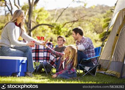 Family Enjoying Camping Holiday In Countryside