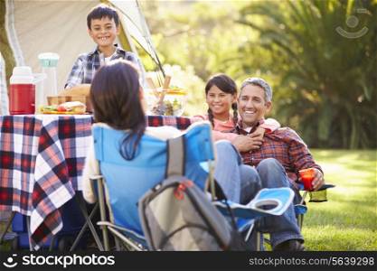Family Enjoying Camping Holiday In Countryside
