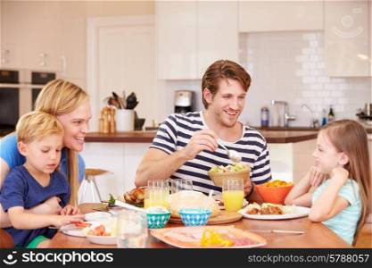 Family Enjoying Meal At Home Together