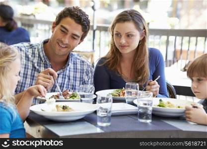 Family Enjoying Meal At Outdoor Restaurant