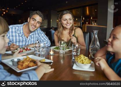 Family Enjoying Meal In Restaurant